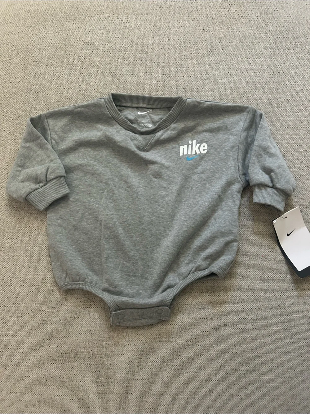 Nike Grey Baby Sweatshirt Bodysuit with White Logo and Blue Swoosh